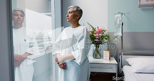 Image of Sad, woman and thinking at window in hospital with stress, anxiety or fear of cancer, death or insurance. Senior, patient and depression in clinic with lady worried for future or mental health