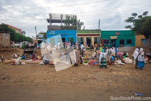 Image of People engage in fruit trade on a dusty roadside street in Weretac, Ethiopia