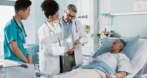 Image of Healthcare, documents and a medical team of doctors checking on a patient in recovery or rehabilitation. Medicine, teamwork and explain with a group of health professionals in a hospital for wellness