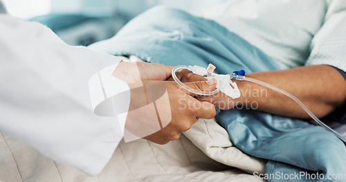 Image of Holding hands, support and doctor with patient with iv drip in medical emergency hospital or clinic bed for medicine. Professional, healthcare and surgeon consulting person in surgery with care