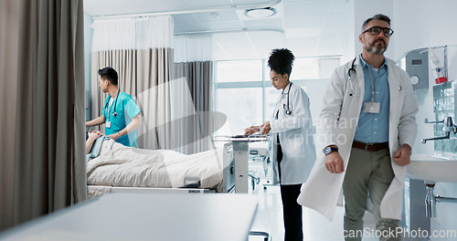 Image of Medicine, hospital and a healthcare team of doctors checking on a patient in recovery or rehabilitation. Medical, teamwork and consulting with a group of health professionals in a clinic for wellness