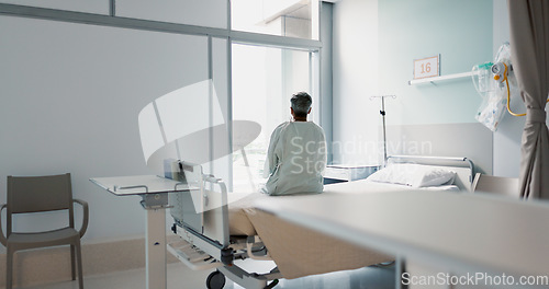 Image of Back, healthcare and a woman on a hospital bed by the window in recovery or waiting for a visit. Medical, cancer and a patient thinking about the future of medicine in a health clinic for treatment