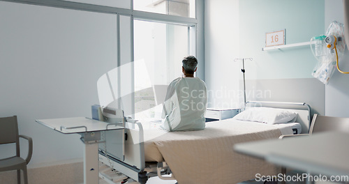 Image of Back, healthcare and a woman on a hospital bed by the window in recovery or waiting for a visit. Medical, cancer and a patient thinking about the future of medicine in a health clinic for treatment