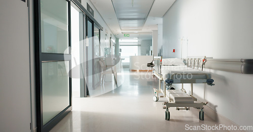 Image of Healthcare, hospital and empty hallway with bed for medical care, health insurance and help in surgery. ER, emergency and lobby at clinic with stretcher for wellness, service and support in medicine.