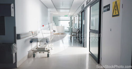 Image of Healthcare, hospital and empty hallway with bed for medical care, health insurance and help in surgery. ER, emergency and lobby at clinic with stretcher for wellness, service and support in medicine.