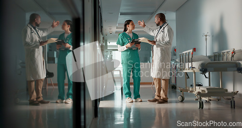 Image of Doctors, man and woman in documents, corridor and planning for surgery, advice or tablet in hospital. Medic, nurse and teamwork with chat, mentorship or brainstorming for medical innovation in clinic