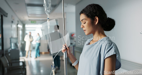 Image of Sad, healthcare and a woman with an iv drip at hospital for medicine, wellness and recovery from virus. Depression, thinking and a clinic patient with treatment stress, burnout or anxiety while sick