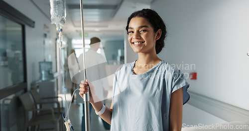 Image of Iv drip, patient and portrait of happy woman in a hospital or clinic corridor with treatment for recovery from surgery. Intravenous, medicine and person with medical insurance for care and health