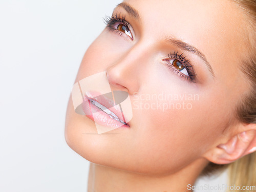 Image of Thinking, beauty and woman with makeup on a studio background for skincare and wellness. Young, idea and a model or girl with a dream of cosmetics, grooming or health of facial skin with dermatology