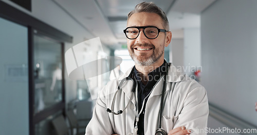 Image of Doctor in portrait, senior man with arms crossed and healthcare, smile with confidence at hospital with pride and help. Medical professional, trust and happy at clinic with expert and stethoscope