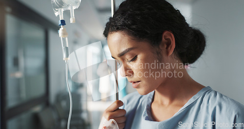 Image of Sad, breathing and a woman with an iv drip at hospital for medicine, wellness and recovery from virus. Depression, thinking and a clinic patient with treatment stress, burnout or anxiety while sick