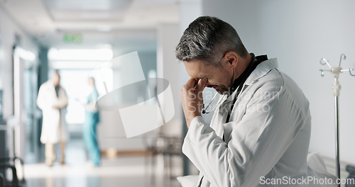 Image of Stress, grief or fail with a mature doctor in a hospital looking unhappy for healthcare or medical. Depression, mistake or loss with a sad man medicine professional in a professional medicare clinic