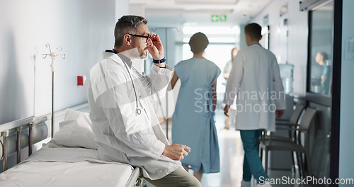 Image of Depression, grief or fail with a mature doctor in a hospital looking unhappy for healthcare or medical. Stress, mistake or loss with a sad man medicine professional in a professional medicare clinic