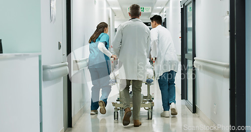 Image of Doctors, hospital bed patient and people walk, consulting and talking about healthcare service wellness. Clinic staff, collaboration and medical team, nurses or surgeon discussion with surgery client