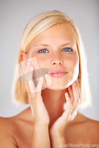 Image of Cosmetics, studio portrait and woman feeling, touch or check smooth skin texture, collagen filler results or skincare treatment. Dermatology self care, anti aging headshot or girl on white background