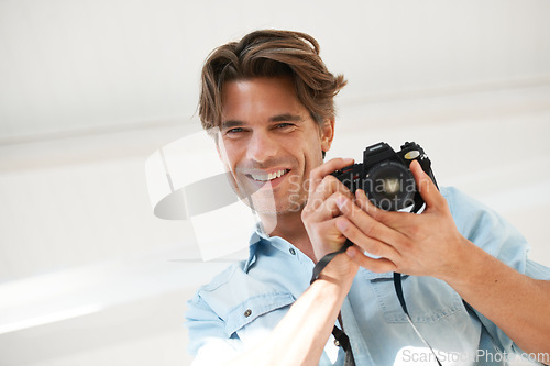 Image of Pride, camera and portrait of man photographer at a photoshoot for creative work project. Happy, photography and handsome young male person with dslr device for art career by white studio background.