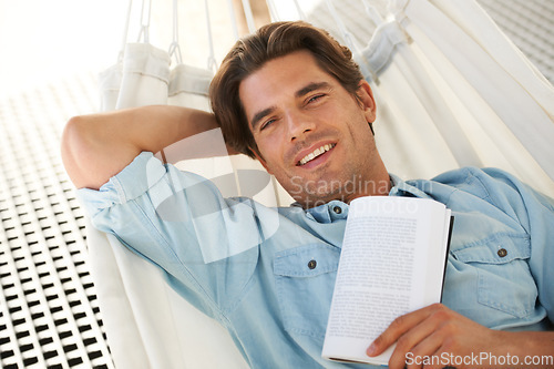 Image of Man in hammock , portrait and smile, reading book and relax, vacation and learning with self care and time alone. Knowledge, literature and novel with happiness, cozy and comfort, leisure or hobby
