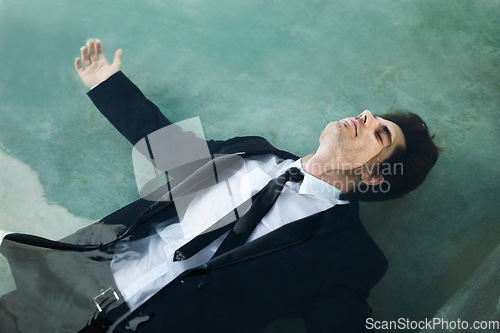 Image of Water, unemployment and a business man in debt during depression of the economy or financial crisis. Finance, pool and challenge with a young corporate employee wet in a suit for recession from above