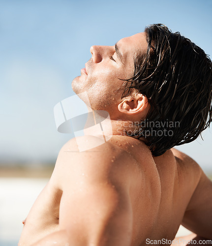 Image of Outdoor, sunshine and man with vacation, beach and tan with break, getaway and weekend trip. Person, calm and guy with seaside holiday, sunlight and relax with basking, wet and summer with freedom