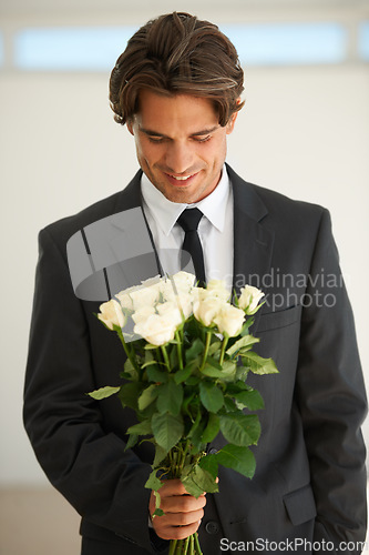 Image of Love, flowers and happy man with bouquet, gift or surprise for date, anniversary or romance. Roses, smile and male person with congratulations present, valentines day proposal or engagement gesture