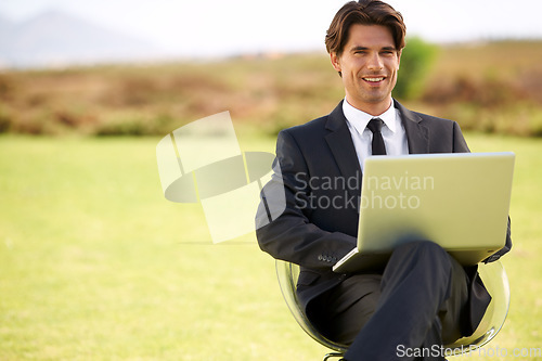 Image of Portrait, laptop and businessman on chair in nature, typing email online on pc or remote work outdoor on mockup space. Computer, smile or professional lawyer in countryside on technology to freelance