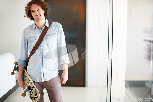 Image of Man, smile in portrait with skateboard in office and sustainable, worker carbon footprint, transportation and creative at startup. Happy, skater for eco friendly travel and professional at workplace