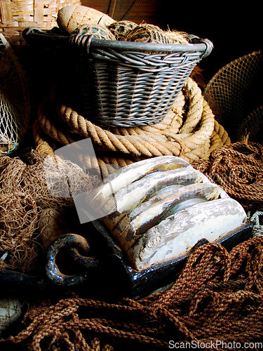 Image of Closeup of fishing basket, lines and rope, net and storage of traditional equipment at port. Tools, fishery and mesh, vintage wood and old metal, retro cordage and antique fishnet in industry