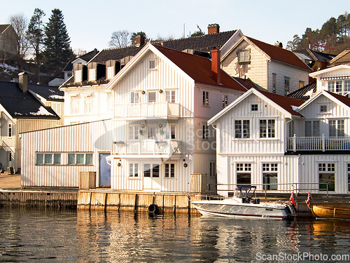 Image of Facade, water and home by lake in Norway, Europe and boat for tourism, travel or vacation. Exterior, house and Scandinavian building by river, vintage architecture or traditional property real estate