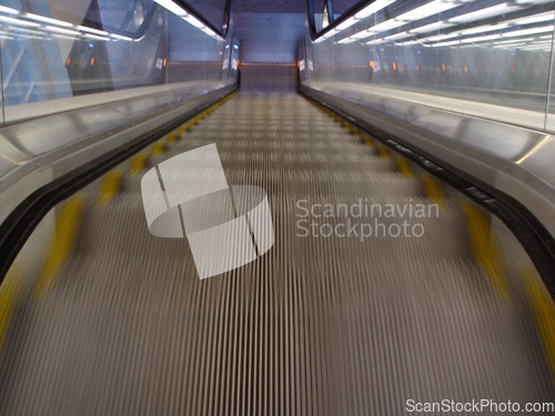 Image of Top view, stairs and escalator in modern building for travel, moving and transport in airport. Metal, steel and closeup of electrical stairway in shopping mall, office or subway for urban commute