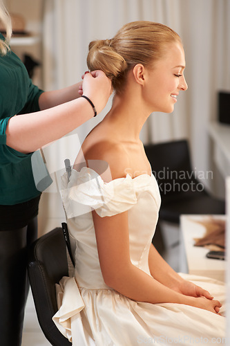 Image of Hairdresser, wedding and woman styling for long, healthy and bridal hairstyle on a young model. Stylist, beauty and beautiful female person from Australia at salon or spa for self care treatment.