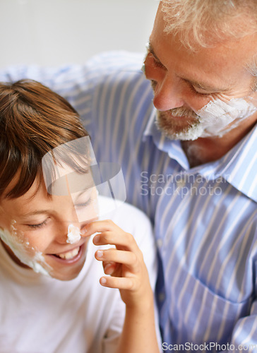 Image of Father, son and face with shaving cream and smile for grooming for development and learning at home. Happy family, man and child with foam or aftershave for hygiene, lifestyle or parenting with love