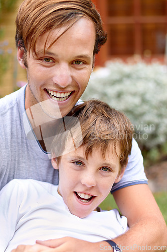 Image of Portrait, man or boy in backyard with smile, hug and bonding in garden of home or house outdoor. Family, people or brother together with happiness and embrace for relax, peace or relationship in yard