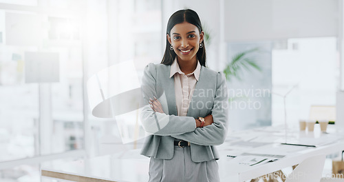 Image of Business woman, portrait and smile with arms crossed in an office for confidence and career pride. Professional entrepreneur person from India at corporate company with positive attitude or happiness