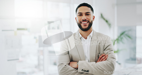 Image of Business man, portrait and smile with arms crossed in an office for confidence and career pride. Professional entrepreneur person from Morocco at corporate company with positive attitude and space