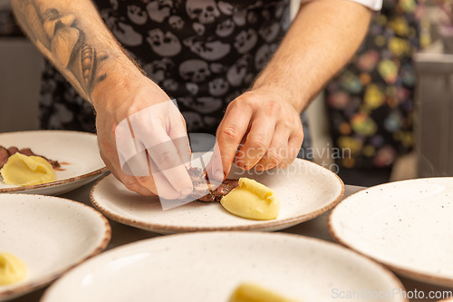 Image of Chef arranging piece of meat