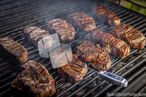 Image of Beef steaks on grill