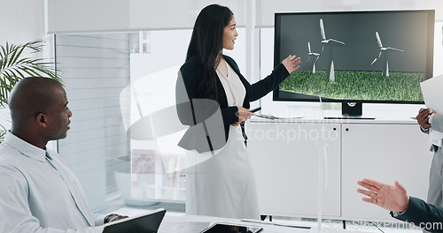 Image of Business woman, windmill presentation and screen in office for innovation, energy and sustainable future. Engineering consultant, leader and team for brainstorming, wind power and clean electricity