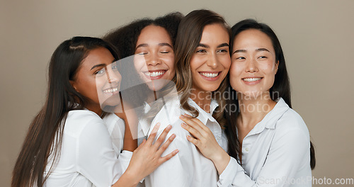 Image of Women, group skincare and beauty with love, hug and support in diversity and inclusion on brown studio background. Friends, model or people smile together and kiss in dermatology, skin care or makeup