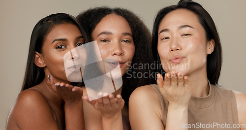 Image of Beauty, women or friends blow kiss in studio for diversity, inclusion and wellness. Face of happy people on neutral background for different facial care, dermatology glow or makeup and cosmetics