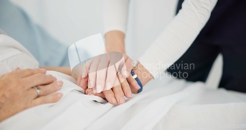 Image of People, holding hands and care for life, support or trust in commitment, understanding or grief at hospital. Closeup of women touching in healthcare for loss, illness or virus on bed at the clinic