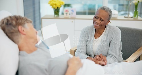 Image of Senior women friends, hospital bed and holding hands with conversation, care and support for recovery from surgery. Clinic visit, empathy and elderly lady with smile, chat and listen with solidarity