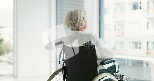 Image of Thinking, woman in wheelchair and window in nursing home or person with disability in the hospital with depression or mental health. Depressed, sad and elderly person with.alzheimer or dementia