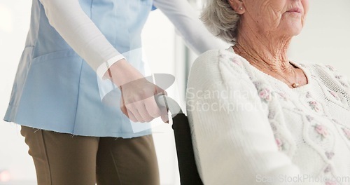 Image of Nurse, senior woman and push wheelchair with helping hand, care and support for rehabilitation in clinic. Medic, elderly person with disability and mobility with empathy, kindness and retirement