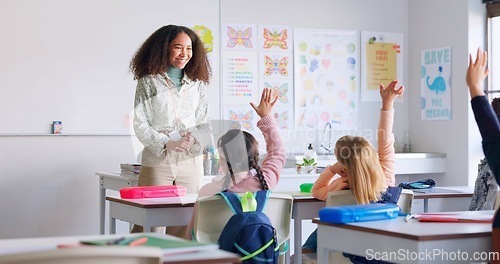 Image of Education, answer and teacher with boy in classroom for learning, discussion and knowledge. Help, studying and hands raised with children and woman at school for why, scholarship and questions