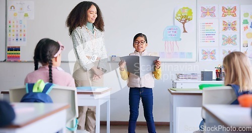 Image of Student, child and reading a book in class for learning, development and communication. A boy kid and teacher woman teaching language, support and assessment in elementary classroom at school