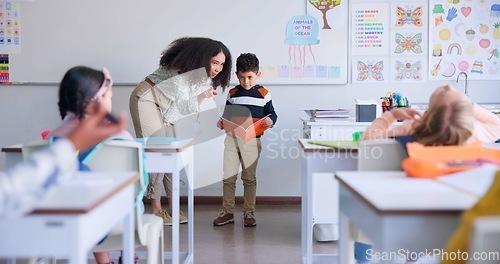 Image of Teacher, child and reading a book in class for learning, development and communication. A boy kid or student and woman teaching language, support and assessment in elementary classroom at school