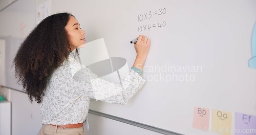 Image of Female teacher, writing and board for mathematics, study and happy for education career with presentation. Woman, classroom and learning expert with pen, problem or challenge for student development