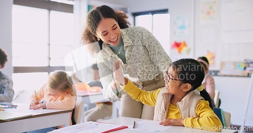 Image of Teacher woman, high five girl and classroom with achievement, success and mentorship for learning. Education, development and students with goals, knowledge and books with celebration at school desk