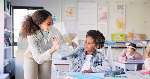 Image of Teacher woman, high five boy and classroom with achievement, success and mentorship for learning. Education, development and students with goals, knowledge and books with celebration, school and desk