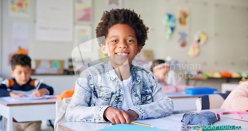 Image of Smile, education and writing with boy in classroom for learning, knowledge and study. Scholarship, happy and future with portrait of young student at school for academy, exam test and project